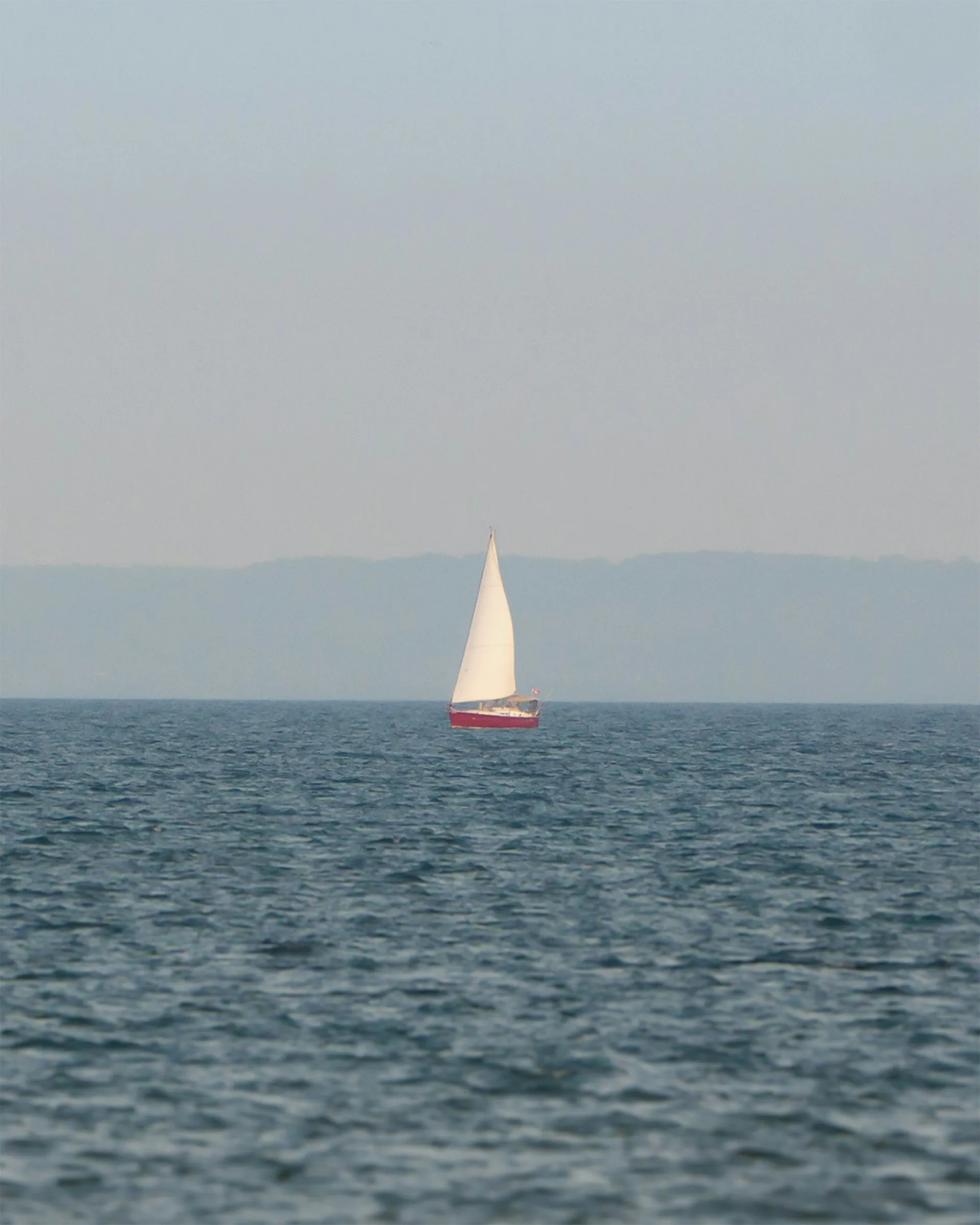 Sailboat in distant lake