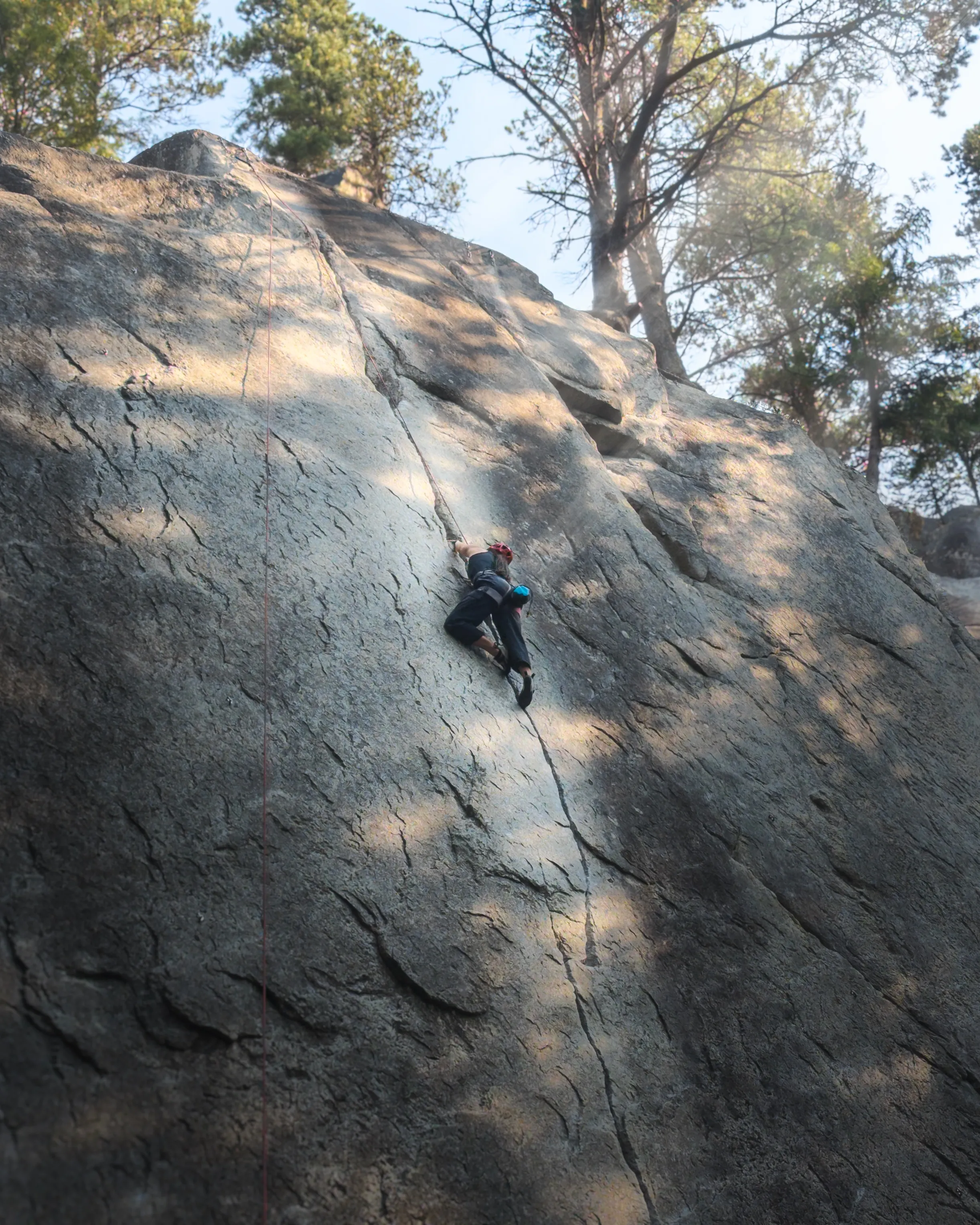 Girl climbing The Zip (5.10a) at Smoke Bluffs, Squamish.