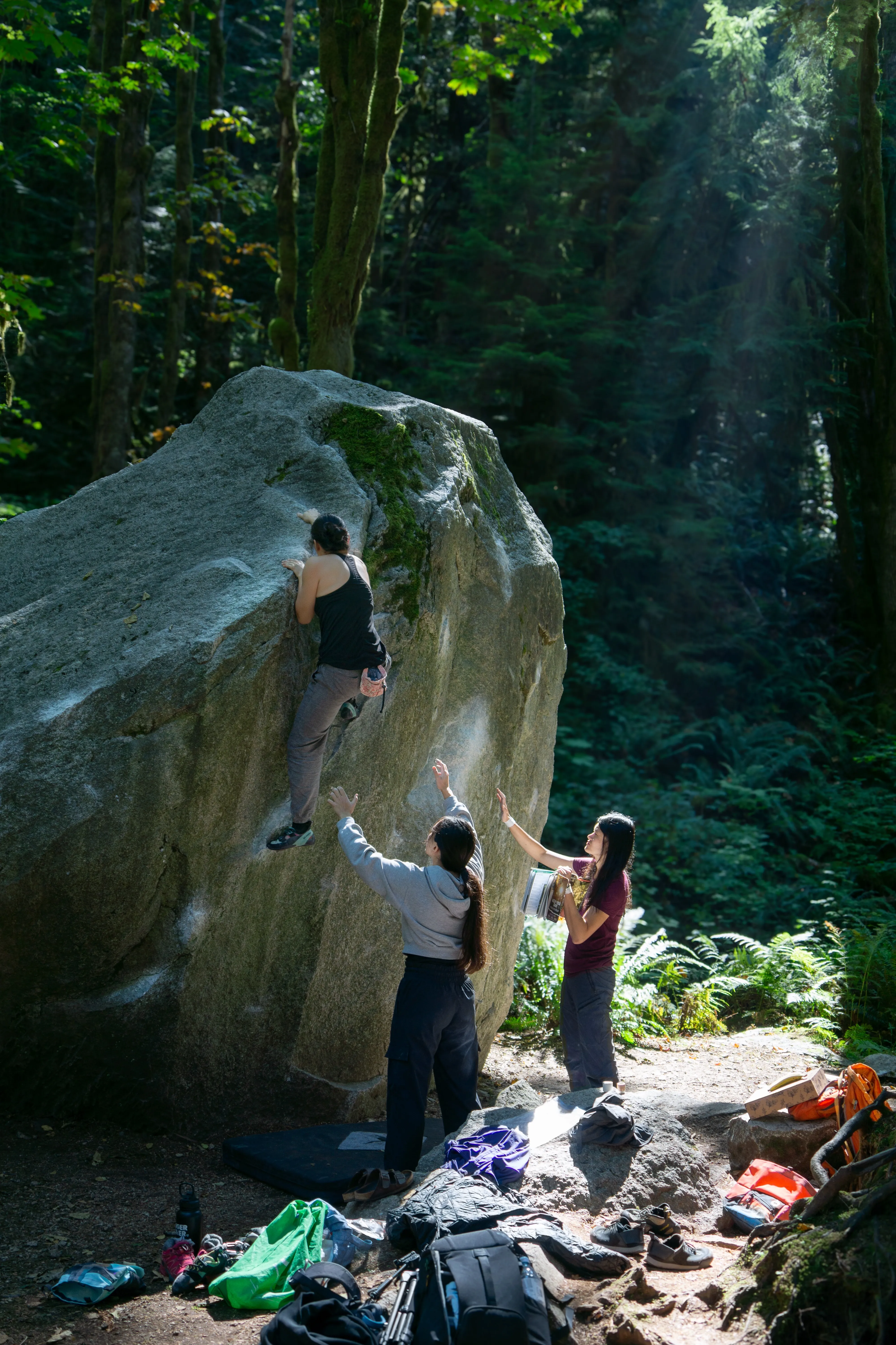 Climbers bouldering and spotting on the North Wall in Squamish.